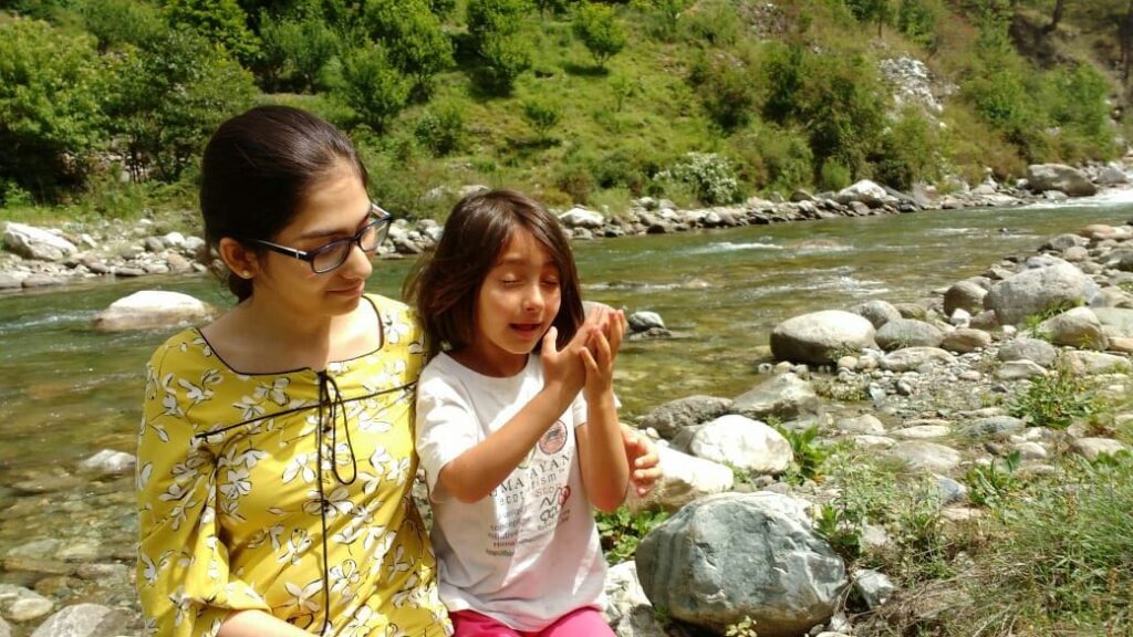 Our trekker enjoying by the riverside in Tirthan valley