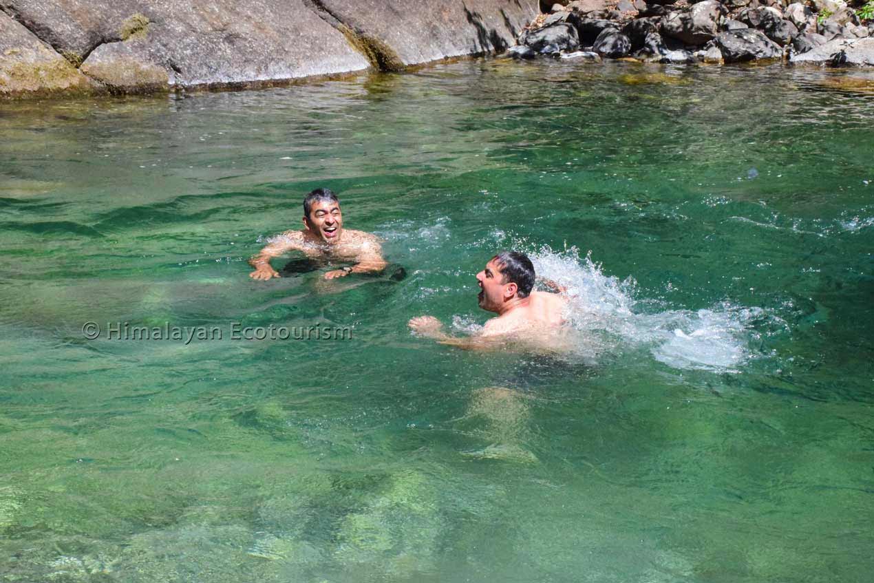 Rejuvenating dip in the Tirthan river